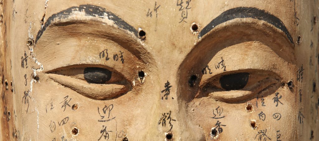 image of the eyes and cheeks of an ancient ceramic acupuncture model